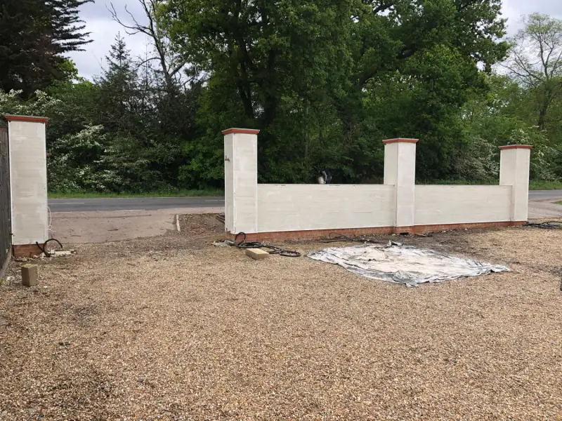 Rendered garden wall and pillars viewed from the driveway